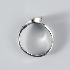 Close-up of minimalist silver wrench ring with adjustable overlapping design for men