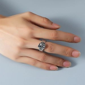 Detail of vintage silver wrench ring on finger showing mechanical industrial design