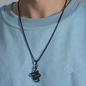 Close-up of 3D textured black snake pendant necklace showing detailed scale patterns