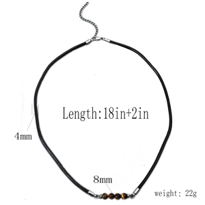 Detail of tiger eye bead necklace with 8mm stones and 4mm black braided leather cord