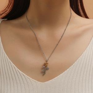 Close-up of dual-tone rose pendant necklace on model with elegant silver chain details