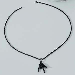 Close-up of black hip-hop LOVE gesture pendant with black wave chain on grey background