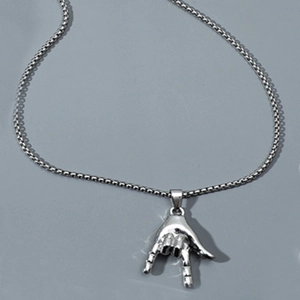 Detailed close-up of a silver hip-hop LOVE gesture pendant with a metallic box chain
