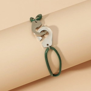 Détail de la corde tressée verte et du fermoir menottes en argent sur le bracelet réglable