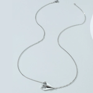 Minimalist silver paper airplane pendant on a sleek stainless steel O-chain necklace