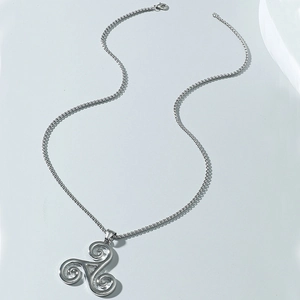 Silver Triskele pendant necklace with Celtic spiral design on minimalist background