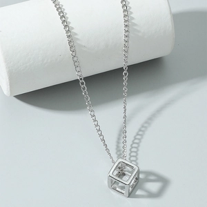 Minimalist geometric necklace featuring a hollow cube pendant with central zircon stone