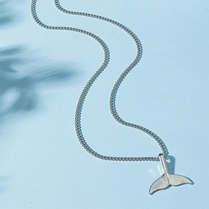 Minimalist silver mermaid tail pendant necklace on light blue background with shadows