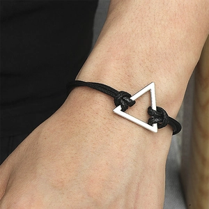 Minimalist black braided cord bracelet featuring a brushed silver triangle pendant on a wrist