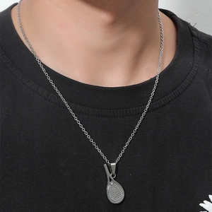 Détail du collier avec pendentif raquette de tennis en argent sur une chaîne longue