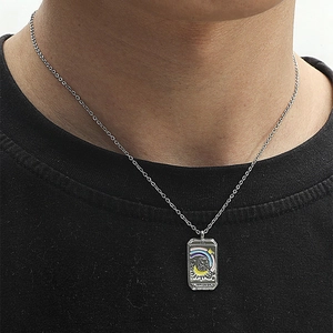Close-up of Empress tarot card necklace featuring colorful enamel details on model