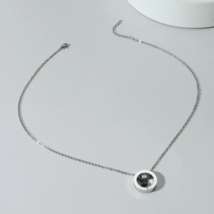 Double ring letter necklace with silver and black love pendants on a minimalist chain
