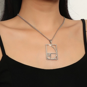 Detailed close-up of a stainless steel Fibonacci spiral necklace on a model