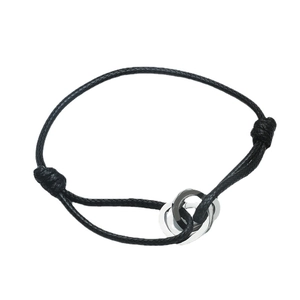 Adjustable black woven bracelet with interlocking silver-toned triple heart rings