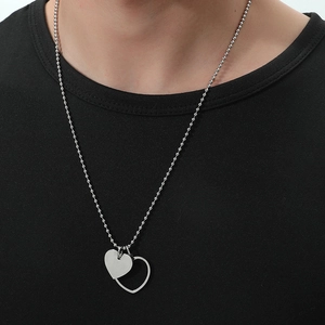 Minimalist double heart pendant necklace with silver ball chain shown on black shirt
