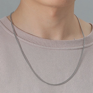 Minimalist irregular stainless steel necklace for men on model with pink knit sweater