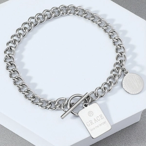 Detail of silver stainless steel chain bracelet with OT toggle clasp and Grace tag