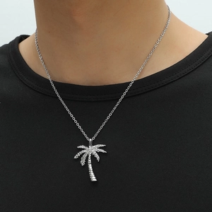Sparkling palm tree pendant necklace with clear crystals on a silver-tone chain
