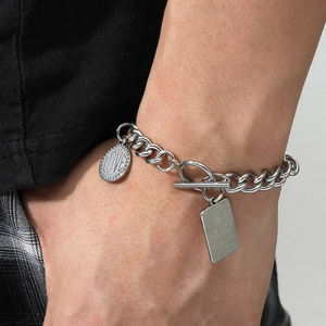 Detailed close-up of stainless steel toggle clasp bracelet with Love and Grace charms