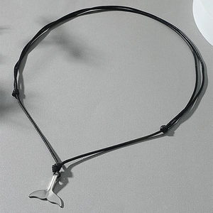 Adjustable black cord necklace with minimalist silver whale tail pendant on grey base