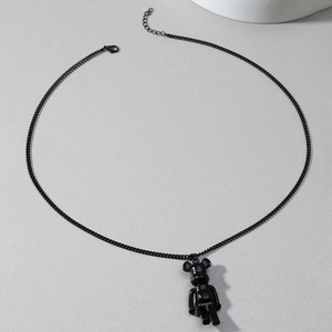 Close-up of a glossy black block bear pendant on a hip-hop style metal link chain