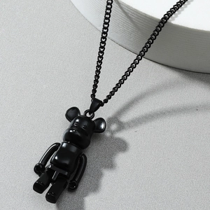 Matte black street style bearbrick pendant necklace on a geometric display stand