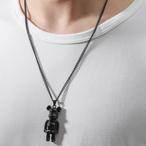 Detail of glossy black mechanical bear pendant on a matching chain for street style