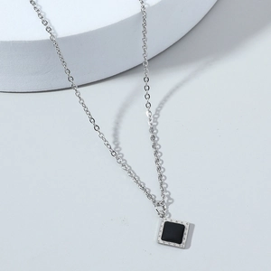 Hip hop style silver necklace featuring square black stone pendant with beaded metal edge