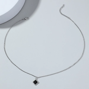Detail of silver chain necklace with black square pendant and adjustable lobster clasp