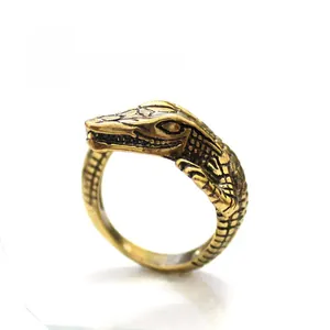 Macro shot of vintage gold crocodile ring showing realistic scale texture and gothic style