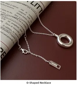 Macro detail of S925 sterling silver hollow ring pendant with AG925 hallmark stamp