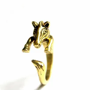 Detail of vintage adjustable horse head ring in antique gold finish with intricate carving
