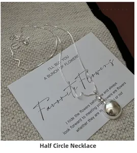 Detailed view of an S925 sterling silver semi-sphere pendant necklace on an elegant card