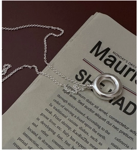 Macro detail of S925 sterling silver hollow ring pendant on fine O-chain necklace