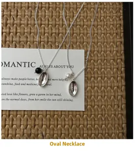 Detail view of S925 silver necklaces with elegant pearl and black onyx oval pendants
