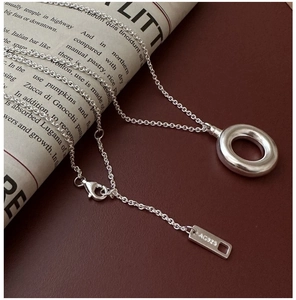 Macro view of S925 sterling silver chain with lobster clasp and Ag925 tag detail