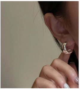 Close-up of minimalist S925 sterling silver chunky C-shaped hoop earrings on model