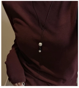 Close-up of S925 sterling silver long sweater necklace with brushed dual bead pendants