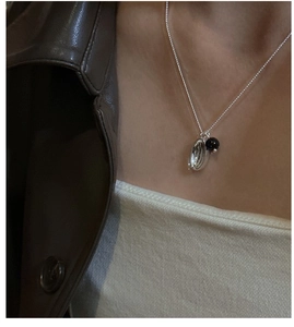 Close-up of S925 sterling silver necklace with capsule and black agate pendant