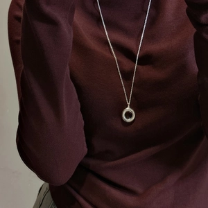 S925 sterling silver hollow circle necklace shown on a dark knit sweater neckline