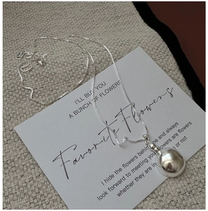 Close-up of S925 sterling silver box chain with a polished minimalist dome pendant
