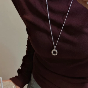 Minimalist S925 silver hollow circular pendant necklace worn on a burgundy turtleneck