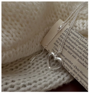 Detailed macro view of S925 sterling silver hollow heart pendant and adjustable chain