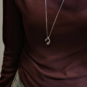 Elegant S925 sterling silver long water drop pendant necklace on deep red sweater