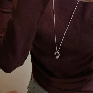 Minimalist S925 sterling silver long teardrop pendant necklace worn on a dark sweater