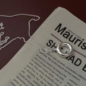 S925 sterling silver necklace with minimalist hollow circular pendant on vintage paper