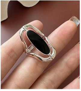 Macro shot of silver S925 openwork ring featuring a large oval black agate stone