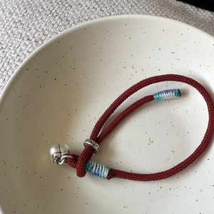 Red woven rope bracelet with S925 silver bell pendant in traditional Chinese style