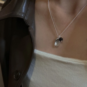 Minimalist S925 sterling silver necklace with spoon pendant and black onyx bead on model