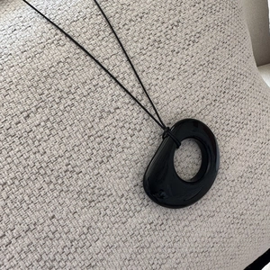 Minimalist S925 silver necklace with irregular black obsidian pendant on textured fabric